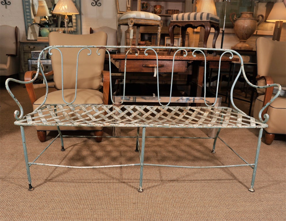 Painted iron park bench with iron lattice seat and scroll-form back