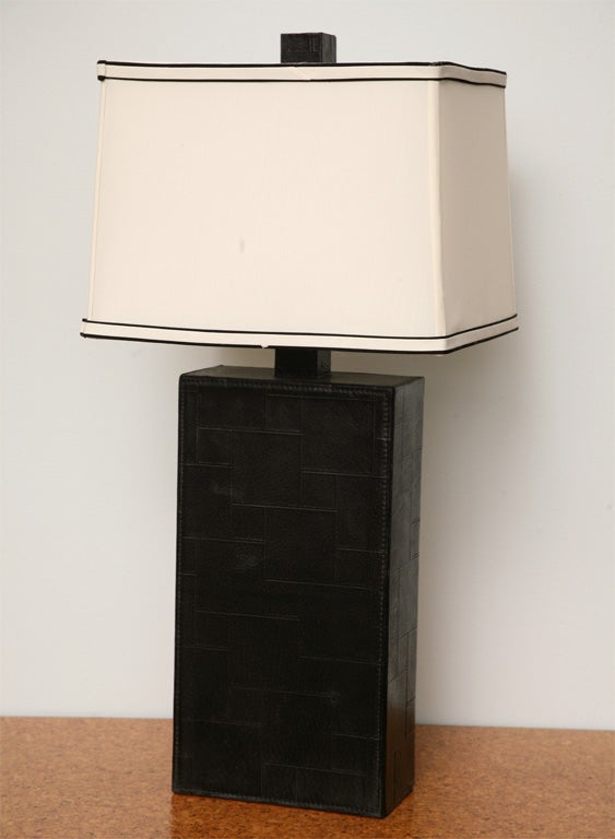 The rectangular body covered in black leather in geometric patterning- note 1st height is with shade.