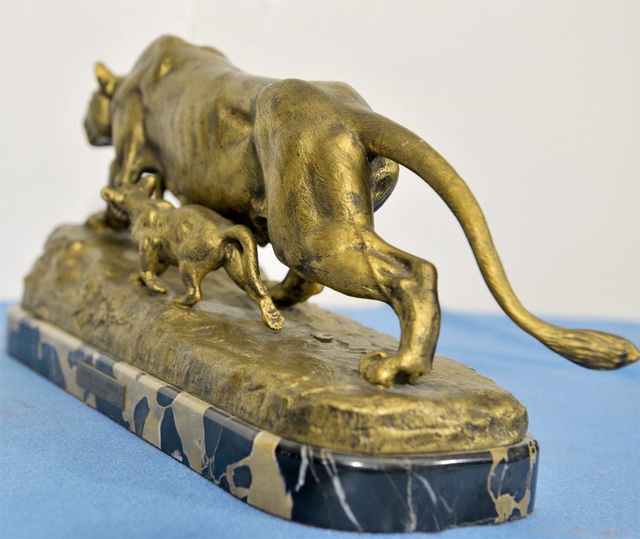 THE FIGURES OF THE STALKING PANTHER AND TWO CUBS ABOVE A BRONZE BASE STAMPED WITH SIGNATURE 