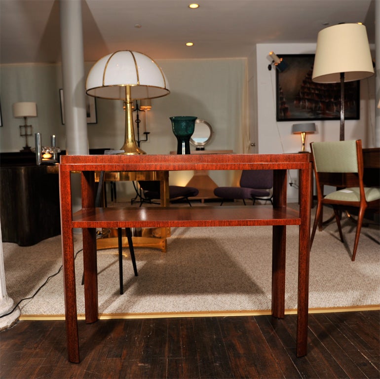 Elegant table of Secupira wood, featuring a stepped top, lower shelf and eliptical shaped legs.  Hand made in the workrooms of Schmieg-Kotzian.     *This unique table was created for the library, in The Gwen and Morris Cafritz Estate, Wash. DC.