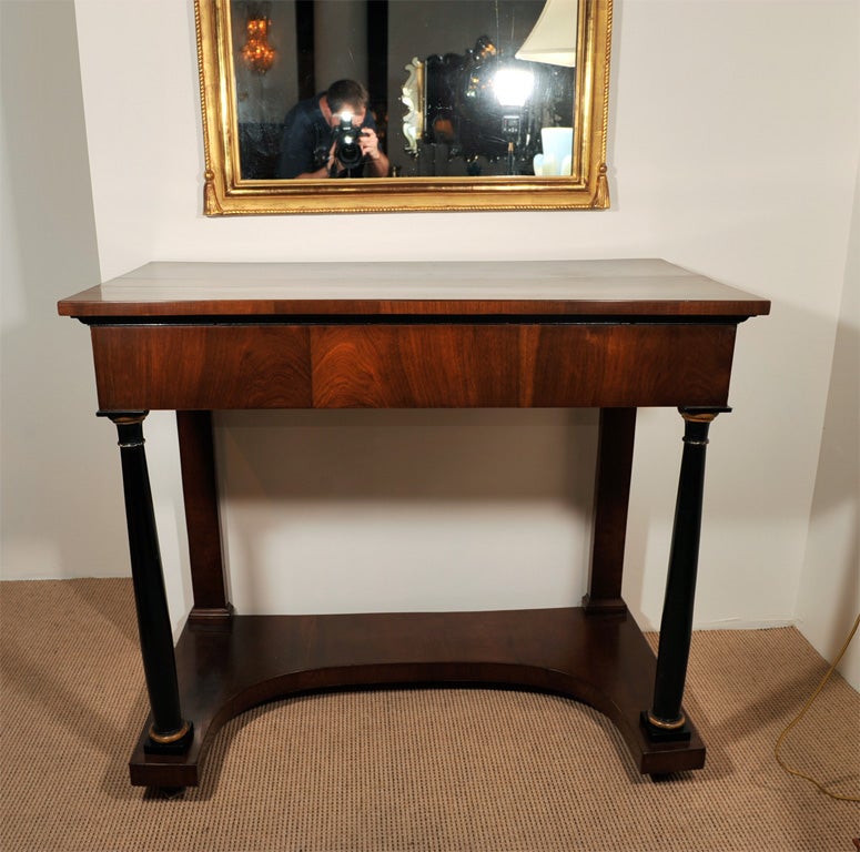Handsome 19th century Empire style console in walnut adorned with ebonized column legs and inverted D-shaped base, Vienna, circa 1840.