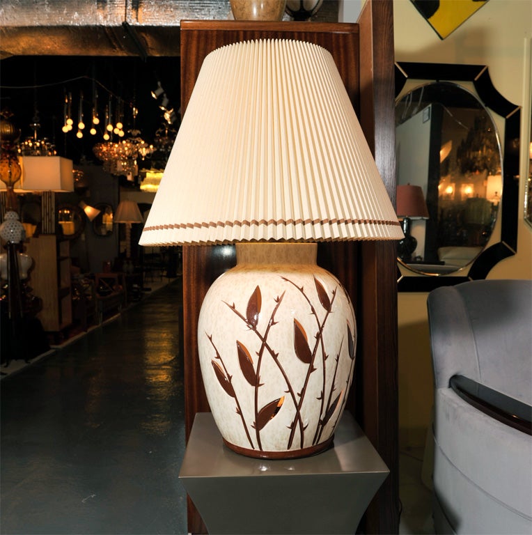 Pair of monumental Mid-Century ceramic table lamps, with illumination voids from inside, and four way switching to light top only, bottom only for accent or night lighting, and both top and bottom, perfect for the country home.
