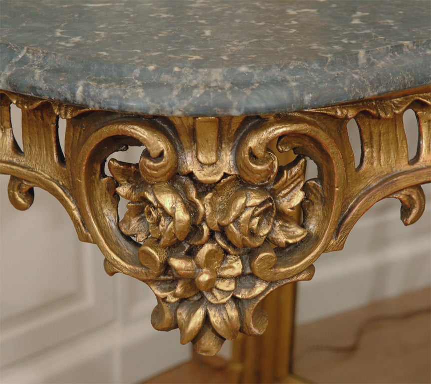 A really nice pr of 19th carved and gilded Louis XV console tables with granite dark verde tops