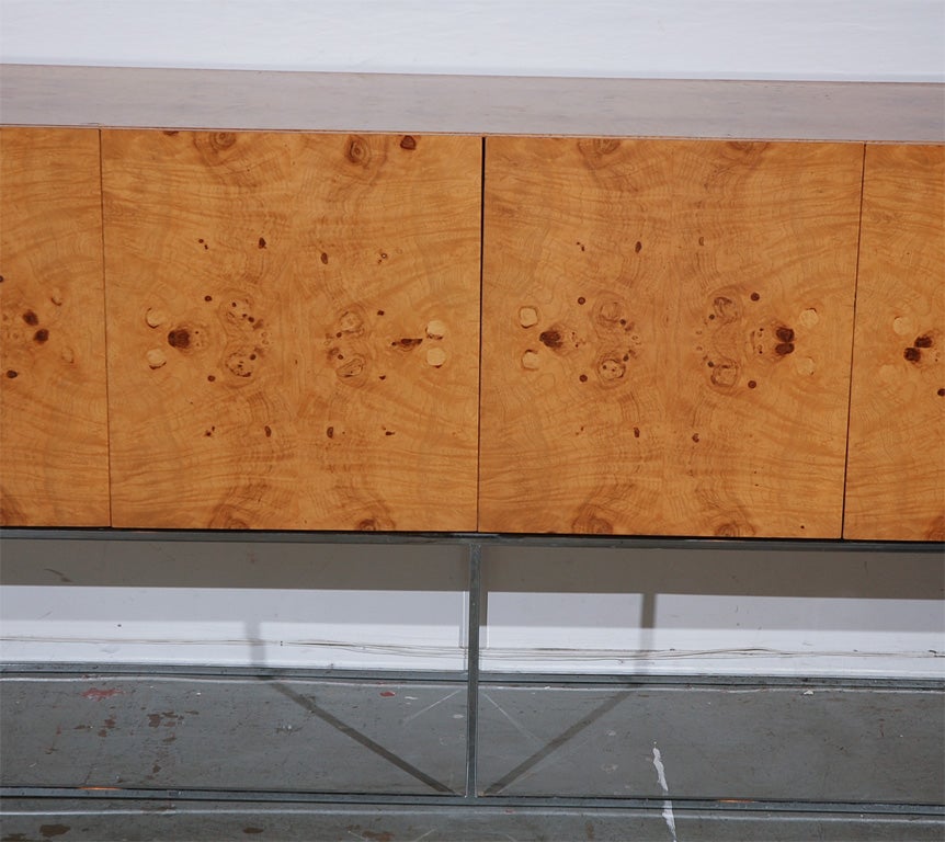 Luxuriously book-matched and highly figured burl olivewood veneers and austerity of line mark this credenza as a Milo Baughman design. Made around 1970 by Thayer-Coggin. <br />
<br />
Price<br />
$8,500<br />
<br />
Condition<br