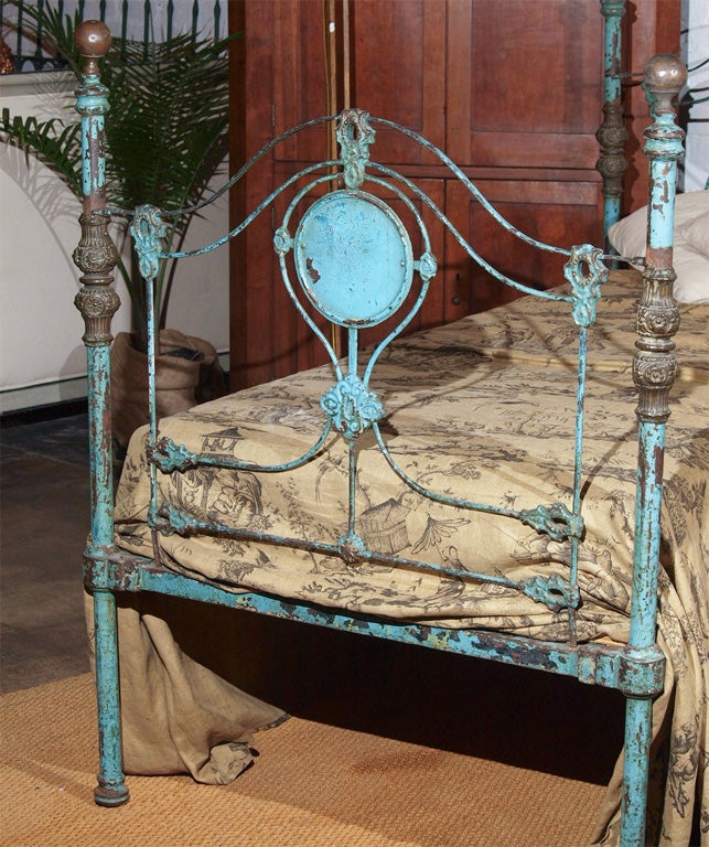 Very decorative iron bed with brass detail.  Beautiful original paint.<br />
Interior measures 40.5