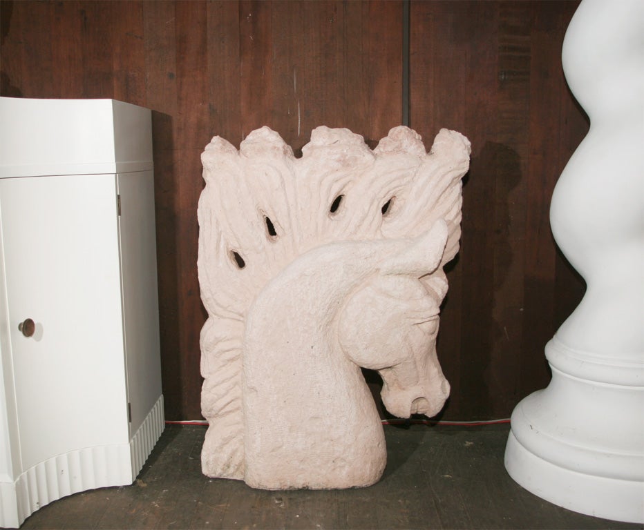 Large pair of stylized plaster horse heads.