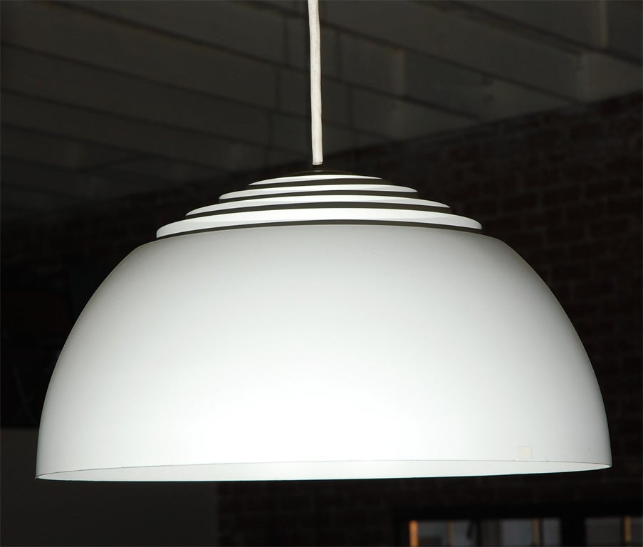 This pair of pendant lights feature a white painted metal and vented dome.