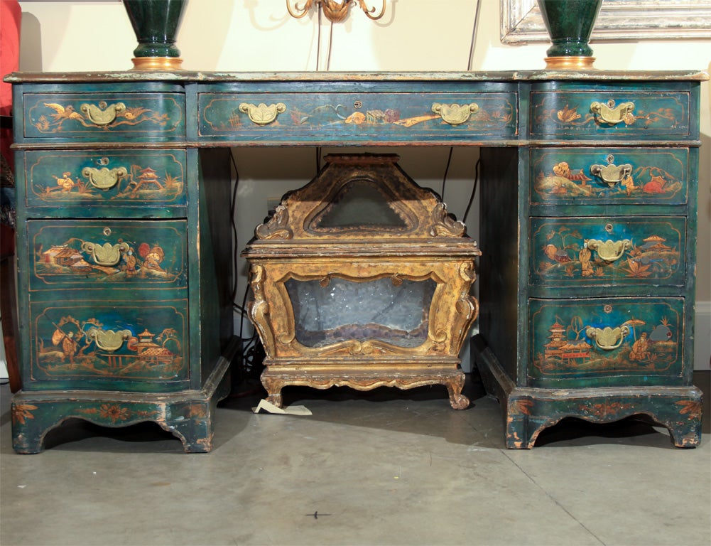 Wonderful Chinoiserie desk with raised gesso decoration.  Beautiful blue green color and charming figures.  This piece is fully painted and decorated on the back side.  The leather top with the gilded edge has been replaced and is in excellent