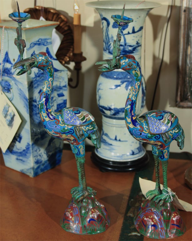 Pair of charming cloisonne cranes with candle holders in their beaks.  Nice scale and very decorative with soft colors.