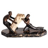 Sculpture of Two Men Hefting a Large Rock