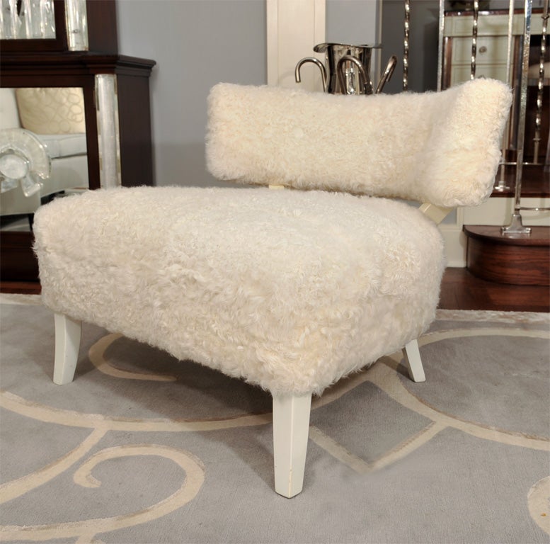 Hollywood lux lounge chair with <br />
abundant seat and klismos back<br />
with button back detailing.  Newly<br />
upholstered in mongolian lamb with<br />
creme lacquered legs.