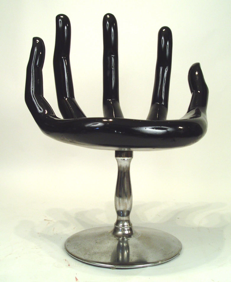 vintage swivel composition chair in the form of a hand. original set piece from the episode of “the Odd Couple” featuring the chair