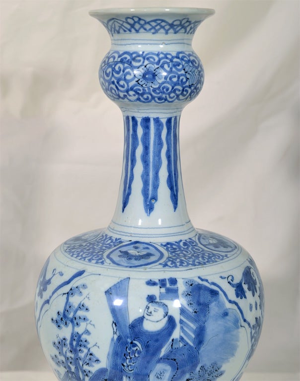 A pair of late 17th century, Dutch Delft, Blue and White, onion mouth vases with chinoiserie designs of a warrior on horseback with bow and arrow, and a nobleman in his garden