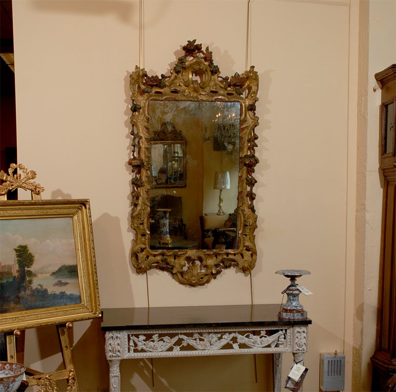 A 18th century Rococo gilt-wood and polychrome painted mirror with carved roses, Italian in origin and dating from the second half of the 18th century.

For Many more fine antiques, including extensive inventory of mirrors, please visit our online