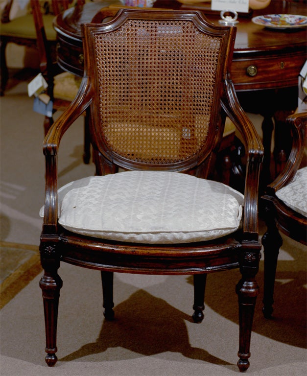 A pair of walnut and cane fauteuils in the neoclassical form, dating from the end of the 18th century and Italian in origin. 

William Word Fine Antiques: Atlanta's source for antique interiors since 1956.