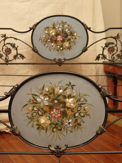 Napolean III tole and mother of pearl decorated cast iron bed with a pagoda style canopy with gilt metal crown, the headboard and footboard with scrolling vines and inset metal panels, the high posts with polychrome enamel and gilt repousse finials.