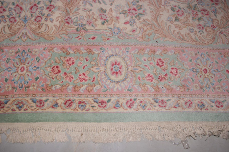 This lovely wool rug can solve many decorating problems.  The colors are subtle and plentiful. The colors are pale greens, cream light pink and rose.
