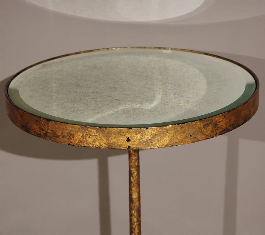 Three-legged gold-leafed side table with scribed foot detail.