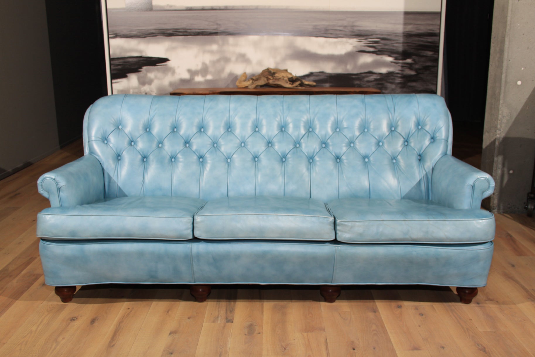 This is the coolest blue leather Chesterfield-style sofa. Grandma only would sit on Betty Blue on Sunday after Church.