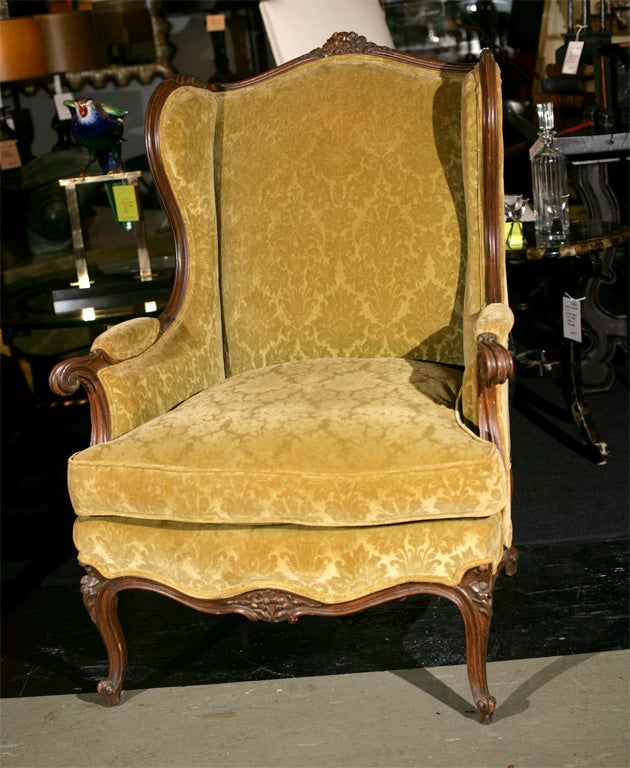 20th Century French carved wood wing chair