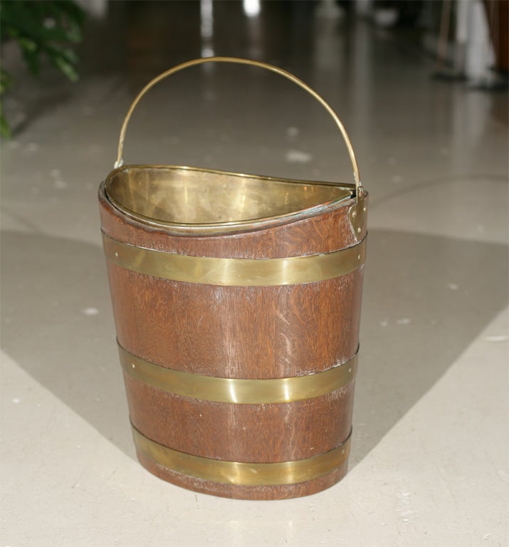 Offered here is an English or Irish Peat bucket made of Mahogany and brass with the original brass liner.