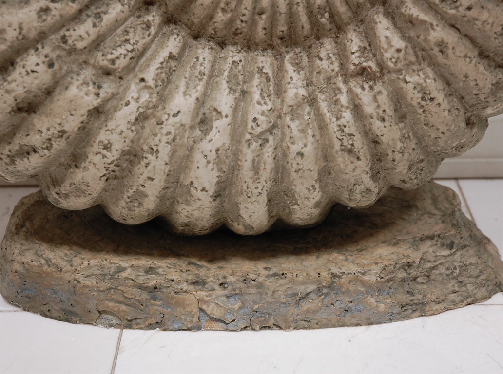 A large Nautilus shell made of fiber glass with a resin coating made to look like fossilized stone. This is a huge piece and would make a great statement on a console or as a garden element. Also see smaller companion piece listed separately.