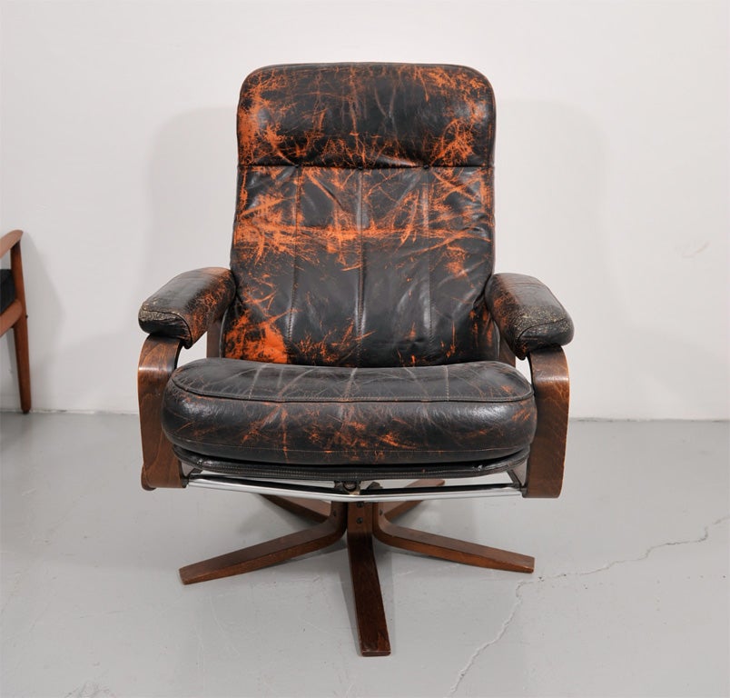 Very comfortable armchair with thick, artificially aged brown leather, with attractive orange markings created by a chemical process. Cushions and frame are in very good condition.