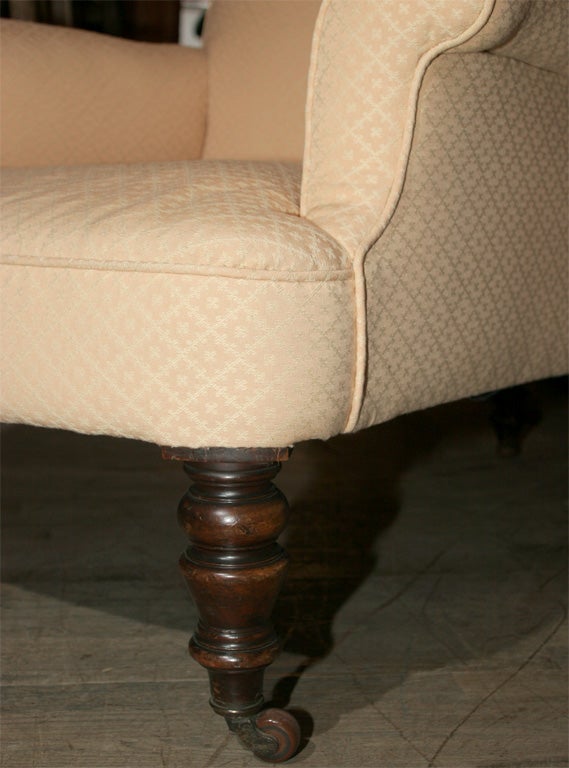 Large comfortable upholstered chairs, mahogany legs with casters