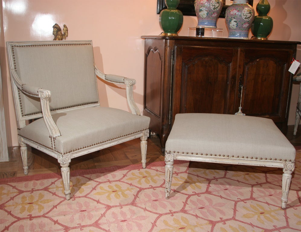 A Pair of Louis XVI Carved and Painted Fauteuils and Tabouret