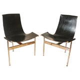 A Pair of "T" Chairs with Black Leather Sling Seats