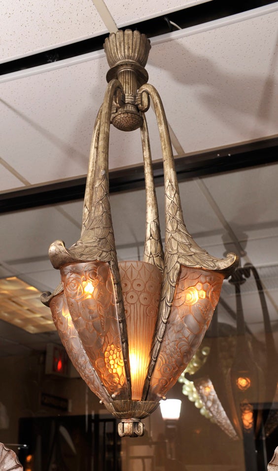 Rare French Art Deco chandelier by Simonet Freres, from circa 1935, in silvered bronze with molded and sepia-patinated glass shades.