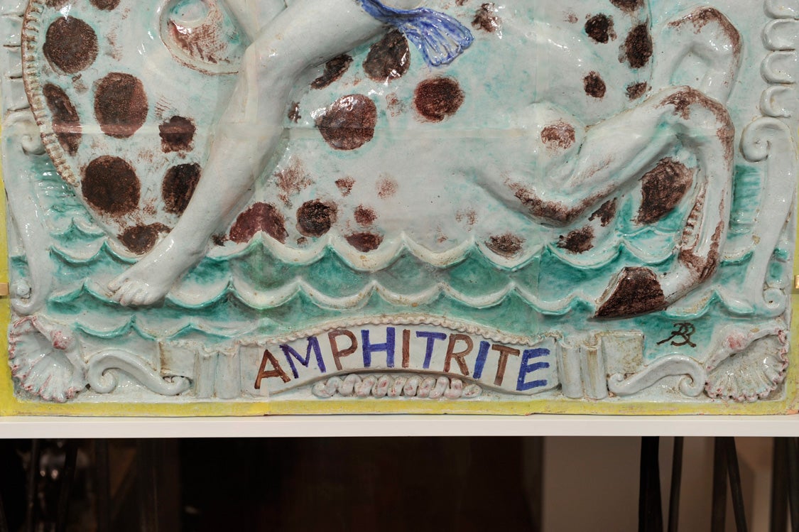 René Buthaud (1886-1986).

"Amphitrite", a ceramic low relief depicting the Greek mythological sea-goddess as a young girl riding a sea horse and holding a shell in her hand.

Titled and monogrammed 'R.B' in the LR corner.