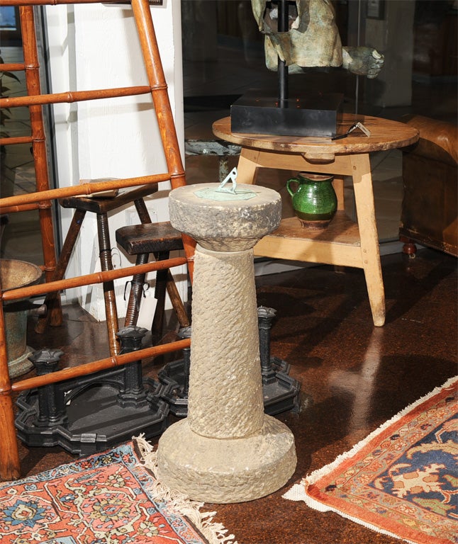 Carved stone and bronze sundail