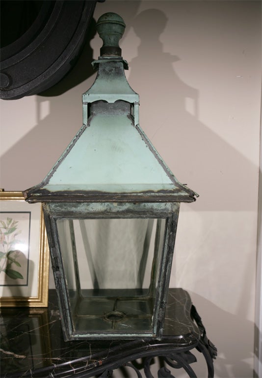 What a charming lantern with its all-natural verdigris surface and original glass!  It is in beautiful condition and although we can have it fitted with a 4-lite cluster and electrified for any type of mount, we thought someone might like it even