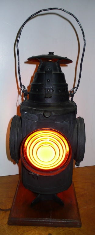 Early Railroad Signal Lantern converted into a Lamp, Swivels on wood base, 2 Amber and 2 Green Lenses.Painted Black, Dressil Railway Lamp & Signal Company, Arlington, NJ USA