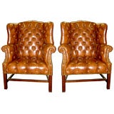 pair of tufted wing chairs