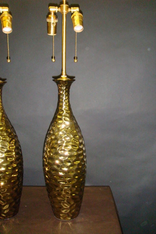 French Pair of 1970's Glamorous gold metallic gouged ceramic lamps. For Sale