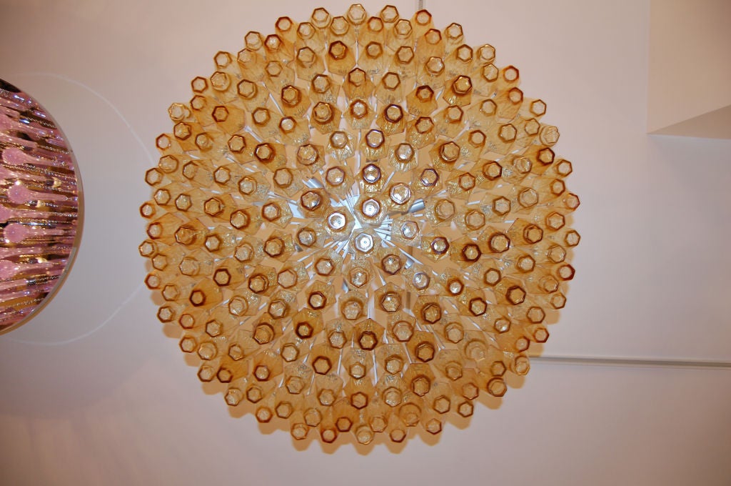 Venini Polyhedral Amber Glass Chandelier<br />
<br />
Venini was founded in 1921 in the Italian glass making capital of Murano-- in truth an island in the waters surrounding Venice. Venini is still active to this day producing high quality