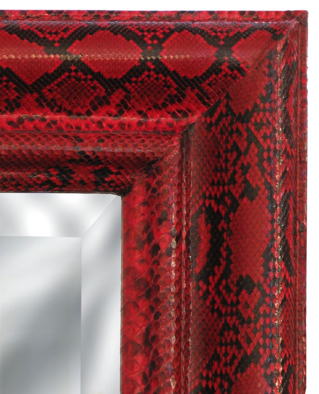 Large wall-mounted mirror with frame covered in red python by Karl Springer, American 1970's