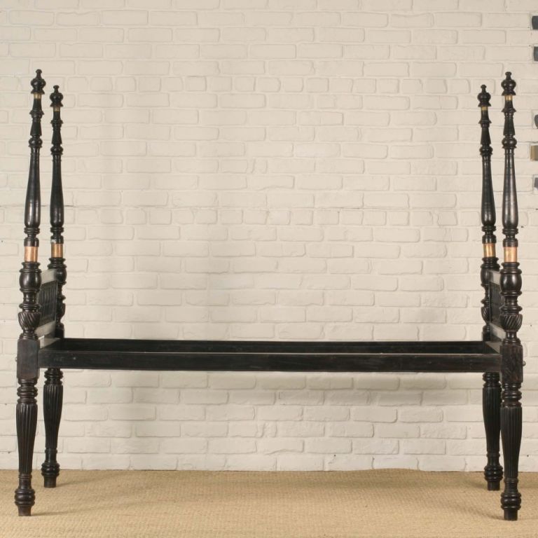 A very rare solid ebony Anglo-Indian Four poster bed. The four turned posts have fluted legs and solid brass connecting hardware. Headboard and footboard have straight top and bottom rails intersected by ebony spindles. The mattress sits directly on