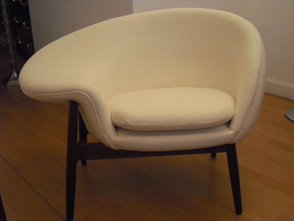 A rare iconographic design by Danish designer, Hans Olsen. The chair has been reupholstered in a white/cream Knoll Boucle fabric.