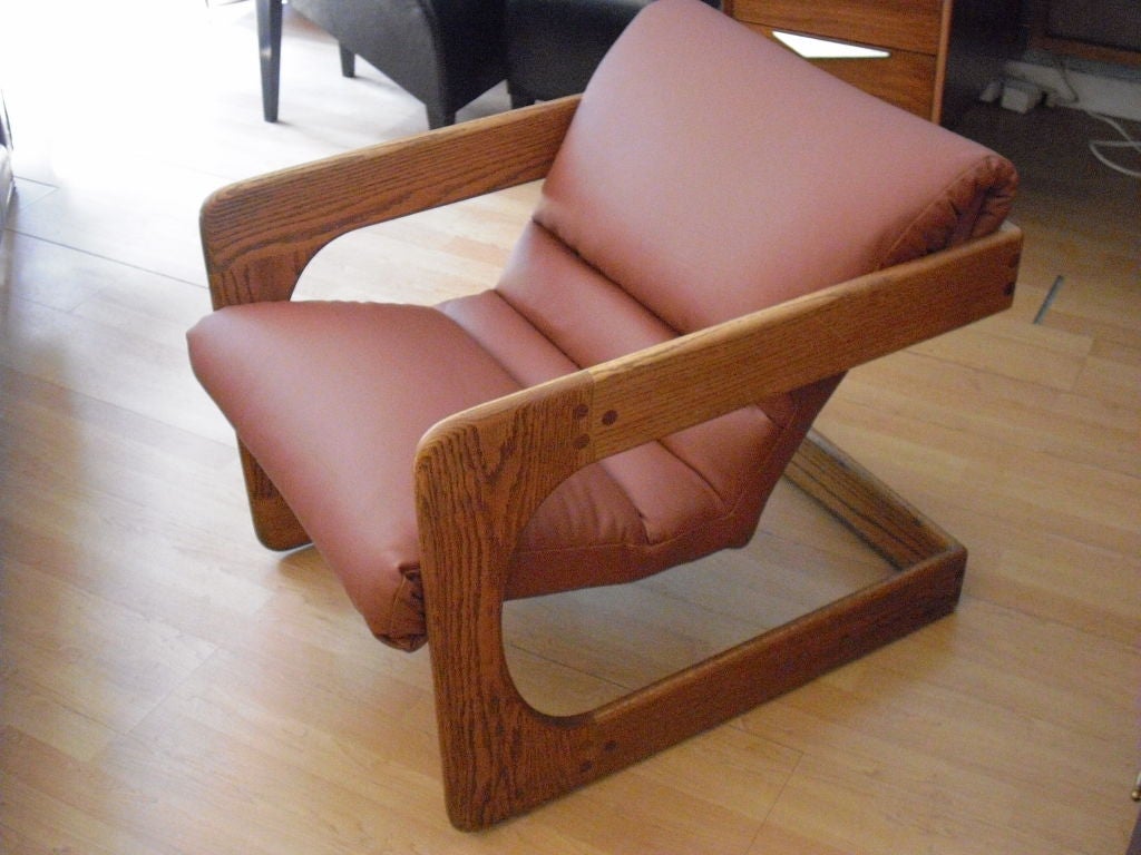 A rare pair of California designed 1970's oak and leather sling chairs by Lou Hodges. The leather is high quality Spinneybeck.