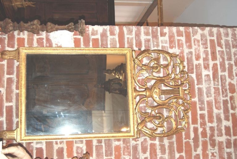 Exceptional Giltwood mirror with Lyre Trophy