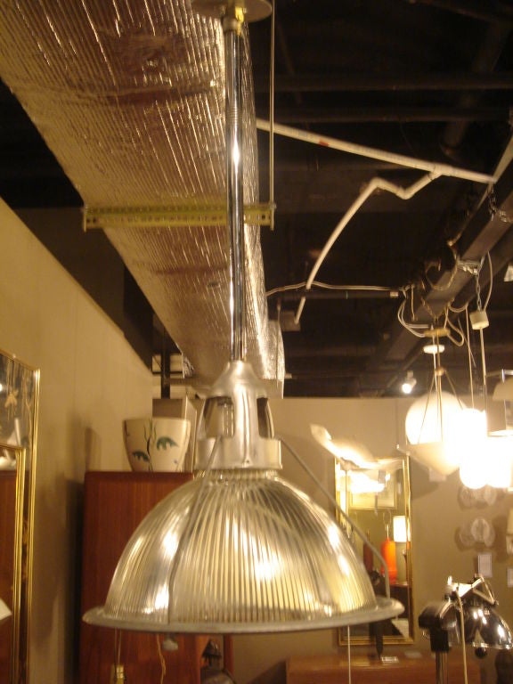 Vintage hanging light fixture with metal frame and stamped Holophane shades. USA, circa 1950. <br />
<br />
Total Height of Light Fixture from ceiling mount to bottom edge is 29 inches (this reflects the total height of light fixture as shown in