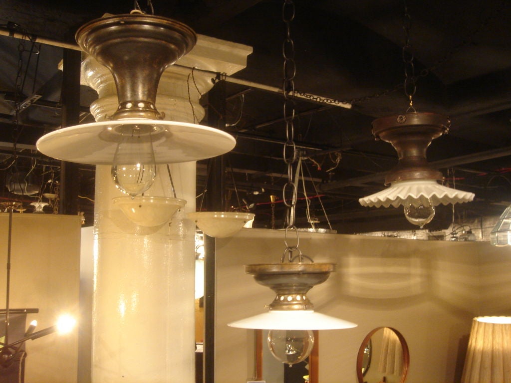 Antique flush mount light fixture with period fluted/ruffled milk glass disk shades. USA, circa 1920.  Please note that the two fixtures on the left have sold; only the one on the far right is available.<br />
<br />
Fixture features a black/brown