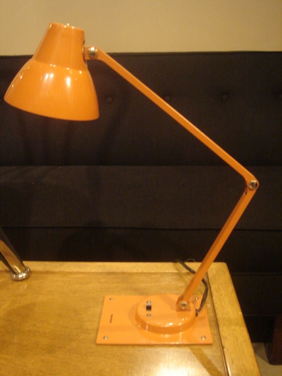 Vintage orange metal task/desk lamp designed by Jay Monroe for Tensor.  USA, circa 1950.<br />
<br />
Features fully adjustable arm and shade, with on/off switch on base.<br />
<br />
Item may be viewed at our showroom at Center 44, 222 East