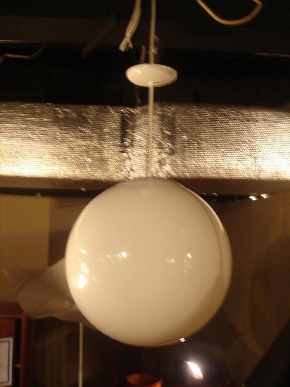 A globe hanging light fixture in the mid-century style.  <br />
<br />
Measures 24 inches in diameter (additional sizes available below).<br />
<br />
Originally designed and made by Lightolier, these lamps were a signature light fixture in