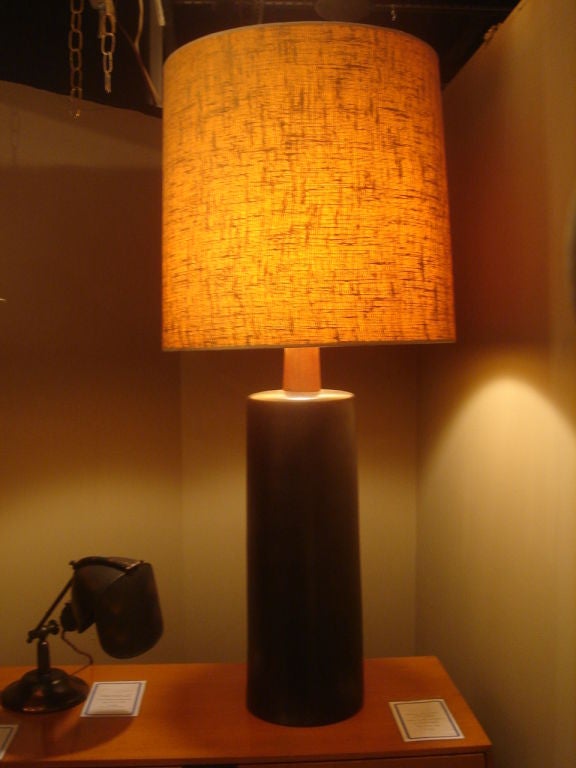Monumental ceramic lamp by Gordon Martz.  USA, circa 1960.<br />
<br />
Features a deep, smooth black matt glaze with signature wood neck.  Signed.  Includes original vintage burlap drum lampshade.<br />
<br />
Please inquire of a pair of lamps