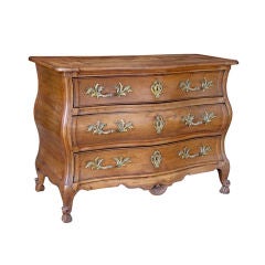 A SUBLIME FRENCH ROCOCO WALNUT BOMBE-FORM THREE DRAWER COMMODE
