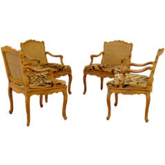 SET OF FOUR FRENCH REGENCE CARVED BEECHWOOD CANED OPEN ARMCHAIRS